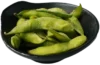 Green edamame pods in a black bowl